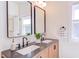 Modern bathroom boasts a double vanity with sleek fixtures and a bright, airy ambiance at 1409 Valley, Durham, NC 27707