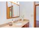 Bathroom vanity featuring a light countertop, wood cabinets, and a decorative mirror above the sink at 1409 Valley, Durham, NC 27707