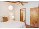 Relaxing bedroom featuring wood ceiling, a decorative light fixture and entrance to the bathroom at 1409 Valley, Durham, NC 27707