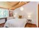 Comfortable bedroom with a wood ceiling, large window, and stylish lighting fixture at 1409 Valley, Durham, NC 27707