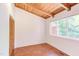Bedroom featuring a light wood ceiling, built in closet and a window that offers outdoor views at 1409 Valley, Durham, NC 27707