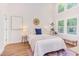 Bedroom featuring bright natural light from many windows, white walls, and stylish decor at 1409 Valley, Durham, NC 27707