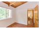 Bedroom showcasing wood ceilings, a window with outdoor views and an open entrance at 1409 Valley, Durham, NC 27707