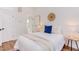 Comfortable bedroom features a plush bed, stylish lighting, and a glimpse into an ensuite bathroom at 1409 Valley, Durham, NC 27707
