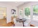 Bright breakfast nook featuring a round table, white chairs, and large windows overlooking the outdoor deck at 1409 Valley, Durham, NC 27707