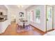 Bright dining area with a view, featuring a stylish table and modern white chairs at 1409 Valley, Durham, NC 27707