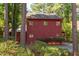 View of the home's exterior showing the wooded surroundings and rustic color at 1409 Valley, Durham, NC 27707