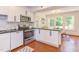 Well-equipped kitchen featuring stainless steel appliances, white cabinetry, and ample counter space at 1409 Valley, Durham, NC 27707