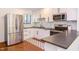 Modern kitchen with stainless steel appliances, white cabinetry, and black countertops at 1409 Valley, Durham, NC 27707
