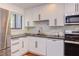 Bright kitchen with stainless steel appliances, white cabinets, and stylish backsplash at 1409 Valley, Durham, NC 27707
