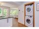 Conveniently located laundry area with stacked washer and dryer units, near the kitchen at 1409 Valley, Durham, NC 27707
