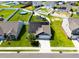 Aerial view of a home with solar panels on the roof, a well-maintained lawn, and a two-car garage at 1561 Dorsett Ln, Creedmoor, NC 27522
