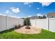 Backyard features a gravel firepit area bordered by brick and a white vinyl fence with a barrel of wood at 1561 Dorsett Ln, Creedmoor, NC 27522