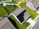 Aerial view of a fenced backyard with a swing set and trampoline with solar panels on roof at 1561 Dorsett Ln, Creedmoor, NC 27522