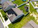 Aerial view of a fenced backyard with a swing set and trampoline with solar panels on roof at 1561 Dorsett Ln, Creedmoor, NC 27522