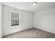Well-lit bedroom with neutral tones, carpet, and window providing natural light at 1561 Dorsett Ln, Creedmoor, NC 27522