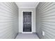 A solid, black front door with decorative panels, offering a secure and stylish entrance to the home at 1561 Dorsett Ln, Creedmoor, NC 27522