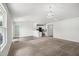 Spacious, bright living room leads to open kitchen with neutral paint and carpet at 1561 Dorsett Ln, Creedmoor, NC 27522
