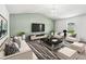 Relax in the living room with comfortable seating, a large screen, and stylish decor at 1561 Dorsett Ln, Creedmoor, NC 27522