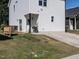 Backyard view of the property with grass and driveway at 157 E Wilson St, Clayton, NC 27520