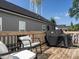 Backyard wooden deck with seating and a grill at 157 E Wilson St, Clayton, NC 27520