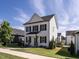 Beautiful two-story home with white siding, black shutters, and a cozy front porch at 157 E Wilson St, Clayton, NC 27520