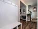 Hallway with coat rack and bench, hardwood floors, and view to the stairway at 157 E Wilson St, Clayton, NC 27520