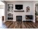 Inviting living room features a cozy fireplace, built-in shelves, and sleek wooden floors at 157 E Wilson St, Clayton, NC 27520