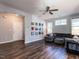 Spacious living room with plush sectional sofa, ceiling fan, and large windows for natural light at 157 E Wilson St, Clayton, NC 27520