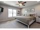 Cozy main bedroom featuring a ceiling fan, neutral colors, and bright windows at 157 E Wilson St, Clayton, NC 27520