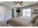 Comfortable main bedroom with a ceiling fan, tv, and windows for natural light at 157 E Wilson St, Clayton, NC 27520