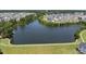 Enjoy this aerial view of a lake in a neighborhood community with green lawns at 1604 Upper Park Rd, Wake Forest, NC 27587