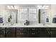 Bright bathroom with double vanity, white countertops, and stylish fixtures at 1604 Upper Park Rd, Wake Forest, NC 27587