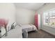 Bright bedroom with a cozy single bed and a modern pink and white closet at 1604 Upper Park Rd, Wake Forest, NC 27587