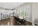 Dining area with large windows, hardwood floors, and modern lighting at 1604 Upper Park Rd, Wake Forest, NC 27587