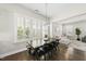 Dining area with large windows, hardwood floors, and modern lighting at 1604 Upper Park Rd, Wake Forest, NC 27587