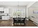 Dining area with large windows, hardwood floors, and modern lighting at 1604 Upper Park Rd, Wake Forest, NC 27587