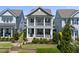 Charming two-story home with a welcoming porch and manicured landscaping at 1604 Upper Park Rd, Wake Forest, NC 27587