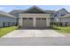 A two-car garage with driveway and black metal fence at 1604 Upper Park Rd, Wake Forest, NC 27587