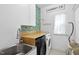 Well-organized laundry room with modern appliances, sink, and storage at 1604 Upper Park Rd, Wake Forest, NC 27587