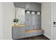 Well-organized mudroom with custom gray cabinetry, drawers, wooden bench, and baskets for storage at 1604 Upper Park Rd, Wake Forest, NC 27587