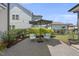 Outdoor living space showcasing a brick patio, seating with cushions, and lush landscaping at 1604 Upper Park Rd, Wake Forest, NC 27587