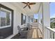 Inviting front porch featuring gray Adirondack chairs, a small side table, and white pillars at 1604 Upper Park Rd, Wake Forest, NC 27587