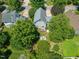 A bird's eye view of the home set amidst mature trees and a well-manicured landscape at 1617 Heritage Garden St, Wake Forest, NC 27587