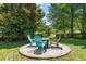A circular patio features a fire pit and seating, perfect for cozy outdoor gatherings at 1617 Heritage Garden St, Wake Forest, NC 27587