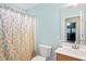 Light-filled bathroom featuring a stylish vanity and a shower with decorative shower curtain at 1617 Heritage Garden St, Wake Forest, NC 27587