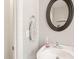 Powder room featuring a modern sink, oval mirror, and fresh decor at 1617 Heritage Garden St, Wake Forest, NC 27587