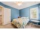Well-lit bedroom boasts a large window, a ceiling fan, and neutral carpeting at 1617 Heritage Garden St, Wake Forest, NC 27587