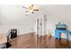 Spacious bonus room features hardwood floors, and a stylish blue desk perfect for entertainment at 1617 Heritage Garden St, Wake Forest, NC 27587