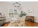Bright dining room with hardwood floors, chandelier, and plenty of natural light at 1617 Heritage Garden St, Wake Forest, NC 27587